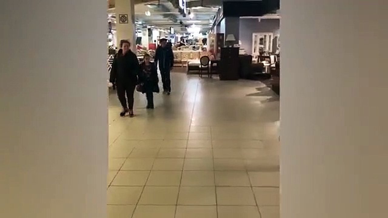 Prankster attempts to stride out of furniture store carrying huge sofa above his head