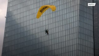 Greenpeace activists on paragliders land on ECB building in climate protest