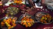 Hindu devotees indulge in buying offerings of mustard oil, marigolds, earthen lamps outside temple