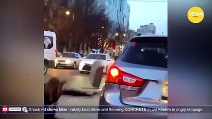 Biker beat driver and throwing CONCRETE at car window in angry rampage