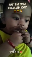 cute baby eating chocolate cookies
