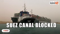 Tugs work to free giant container ship stranded in Suez Canal