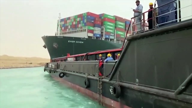 Megaship blocks Suez Canal as workers scramble to refloat grounded vessel