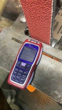 Turning a Nokia 3220 to Dust Using Belt Sander