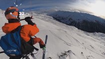 Guy Speedflies With Kite Over Snow Covered Mountains