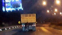 Lazy Cyclist Being Pulled by Truck