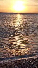 Amazing golden color between sunset and sea waves