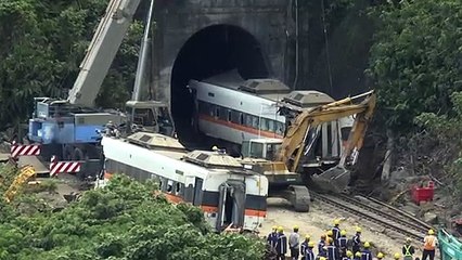 Taiwan salvage teams extract mangled carriage from train crash tunnel
