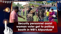 Security personnel assists woman voter get to polling booth in West Bengal