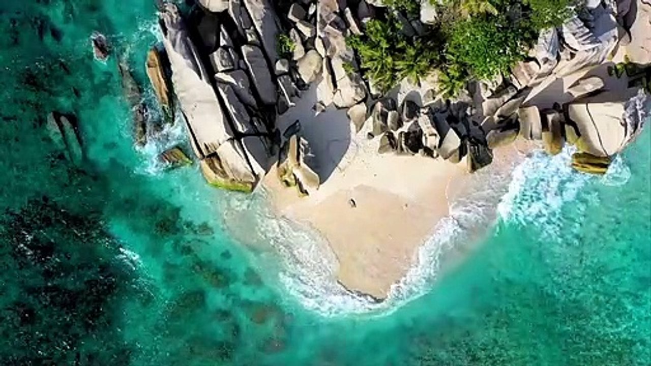 Drawing A Large Heart Figure On The Sand Of A Seashore