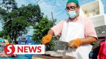 A big career change: Bank clerk becomes fish cutter in Ipoh