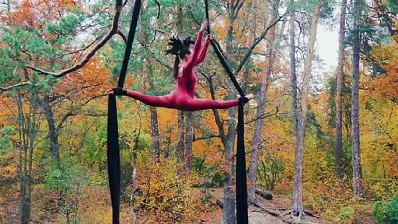 Nature Acrobat performing on an aerial silk above a pond | Licensed footage - See Disclaimer in Description