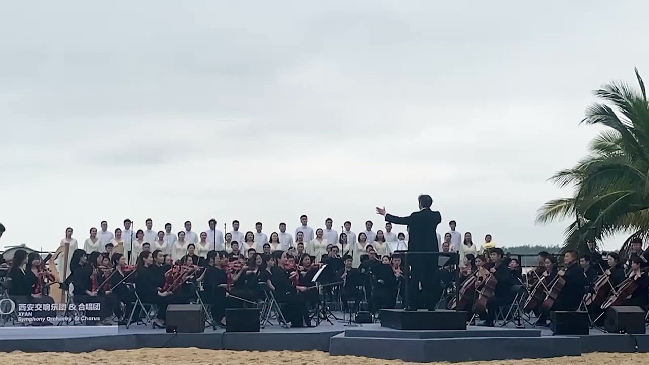 Orchestra plays as China rocket shoots up behin...