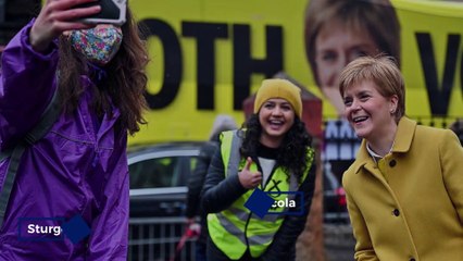 Scots head to the polls through rain,shine and snow