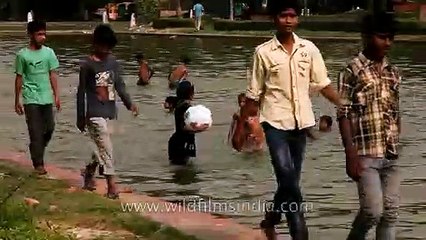Kids cooling of in the water around India Gate