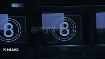 PAN LEFT TO RIGHT ALONG TELEVISION MONITORS DISPLAYING COUNTDOWN, STOP ON CLOSE ANGLE OF ONE MONITOR. MONITORS ARE ON CONTROL PANEL