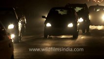 Headlights of passing vehicles at night near Rashtrapati Bhavan, Delhi