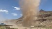 Dust devil towers over Utah farm amid dry heat