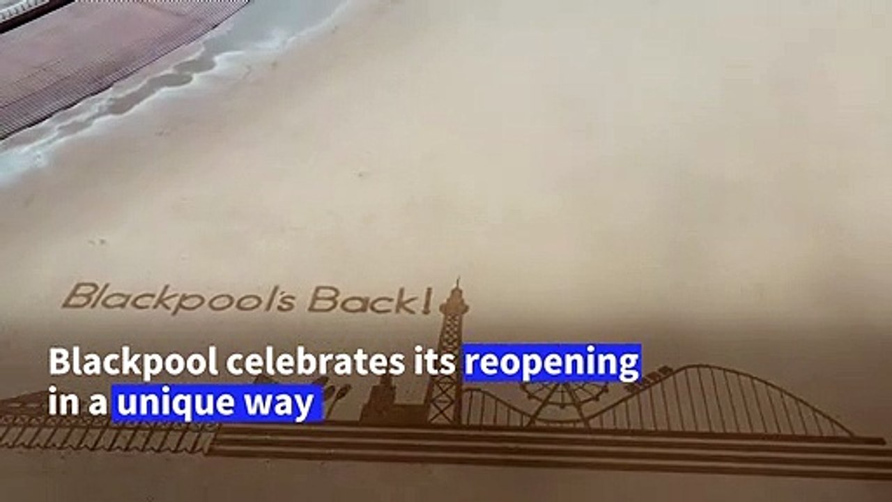 Sand art on English beach celebrates reopening as virus restrictions eased