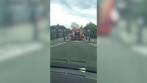 Schoolboys hang on to back of bus in Kirkby in Ashfield