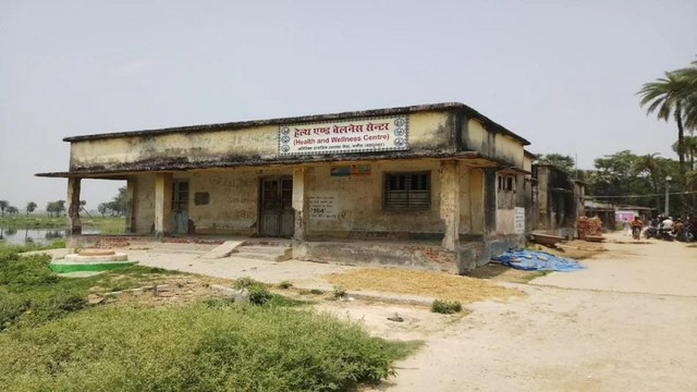 Lock at gate, dung on walls, this is health service in Bihar