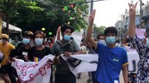 Dozens march briskly through Yangon in flash Myanmar protest