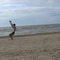 Guy Performs Multiple Consecutive Flips and Split on Beach