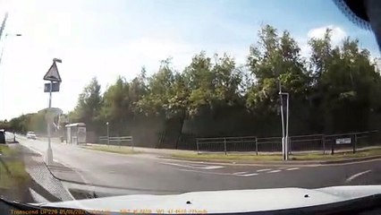 Biker Collides with Back of Car
