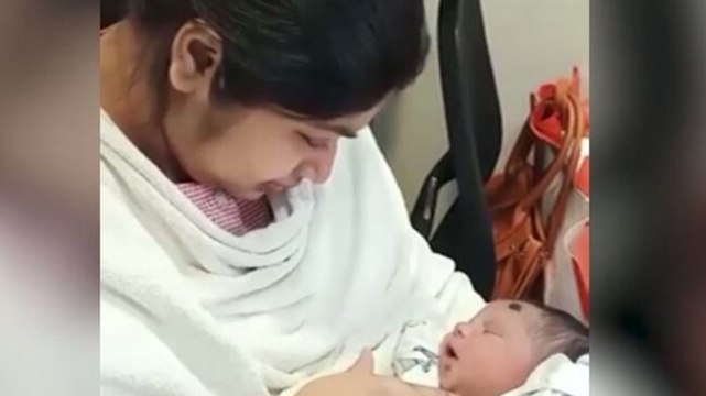 Woman doctor holds her newborn baby for first time after beating Covid-19 