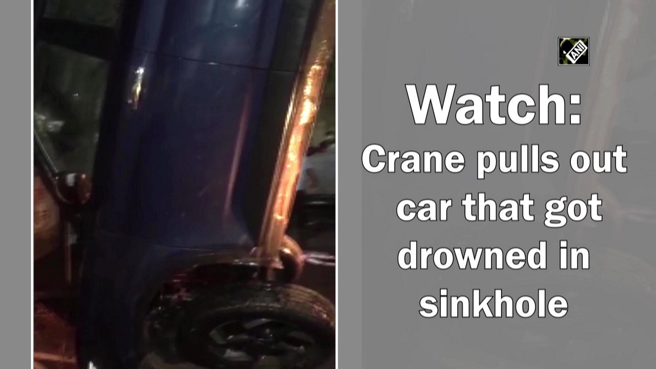 Crane pulls out car that got drowned in sinkhole
