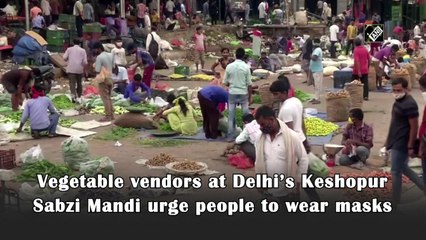 Vegetable vendors at Delhi’s Keshopur Sabzi Mandi urge people to wear masks