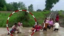 Women saved by people from being washed away in water
