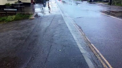 Water rushes into Freeks Lane in Burgess Hill during the downpour on June 28, 2021