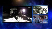 Two astronauts step out of Chinas space station performing a spacewalk