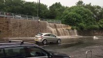 Rainwater streams onto Chesterfield Road following heavy showers in Sheffield. Credit Ian Parkinson