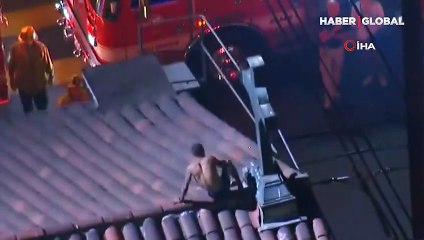 Yarı çıplak halde kilisenin çatısındaki haçları yakmaya çalıştığı anlar kamerada