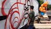Graffiti artist Stefan Lowman, AKA Stog Life, who is creating a mural for the Hells Kitchen Diner on East Bank Road as part of Arch Fun Day, a national event for businesses in railway arches, or in this case, on top of a railway tunnel