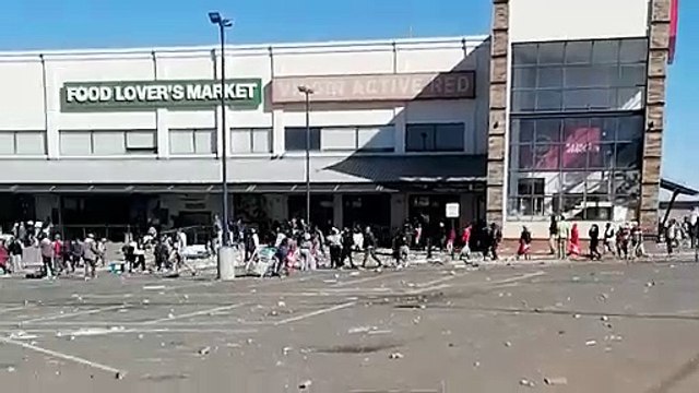 Shocking video shows a crowd of people looting a shopping centre in Soweto as unrest grips South Africa