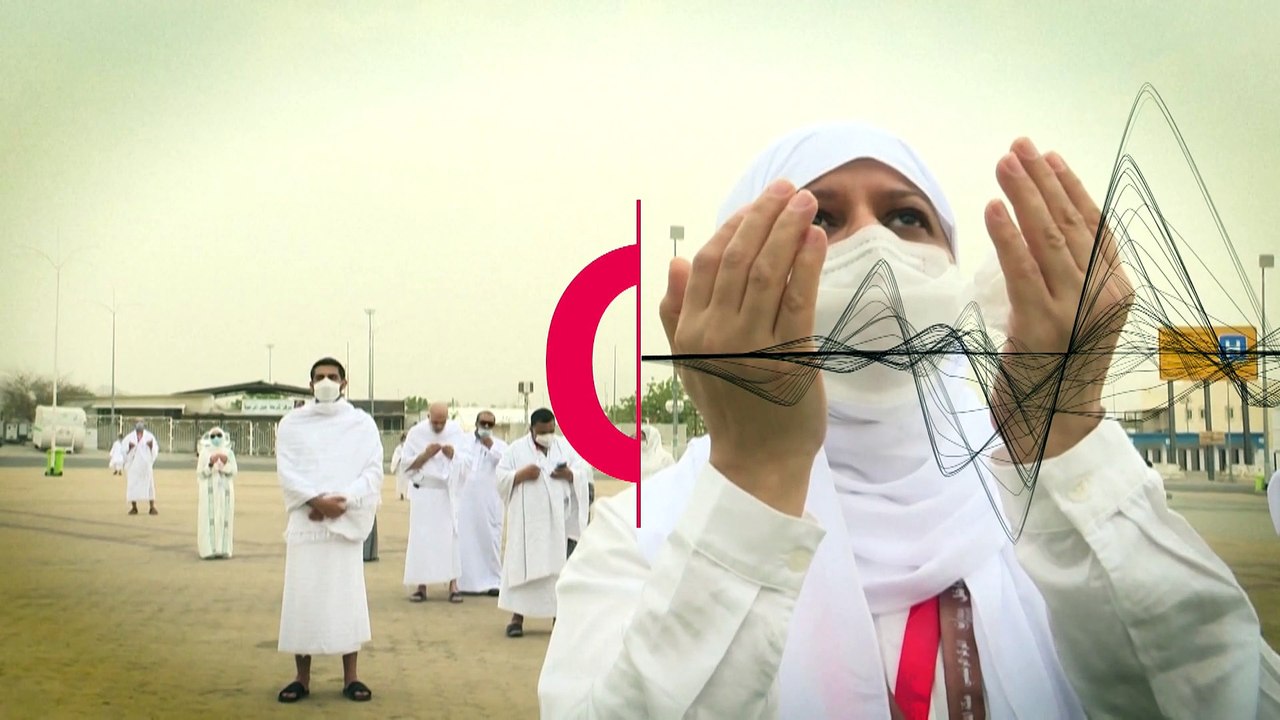Pilgrims pray next to Mount Arafat