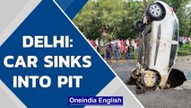 Delhi: Car sinks into pit that appeared after heavy rains in Dwarka | Oneindia News