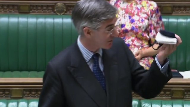 Jacob Rees-Mogg waves face mask in the air but refuses to wear it