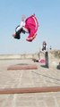 Gymnast Wearing Traditional Indian Long Skirt Does Backflip on Terrace