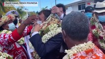 Emmanuel Macron is welcomed with garlands of flowers and seashells on Manihi Island