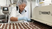 See's Candies is celebrating its 100th year in business. See how the famed brand makes 26 million pounds of candy each year.