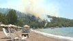 Wildfire burns next to Turkish beach