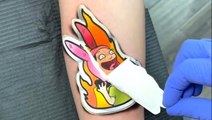 Artist creates cartoon sticker tattoos