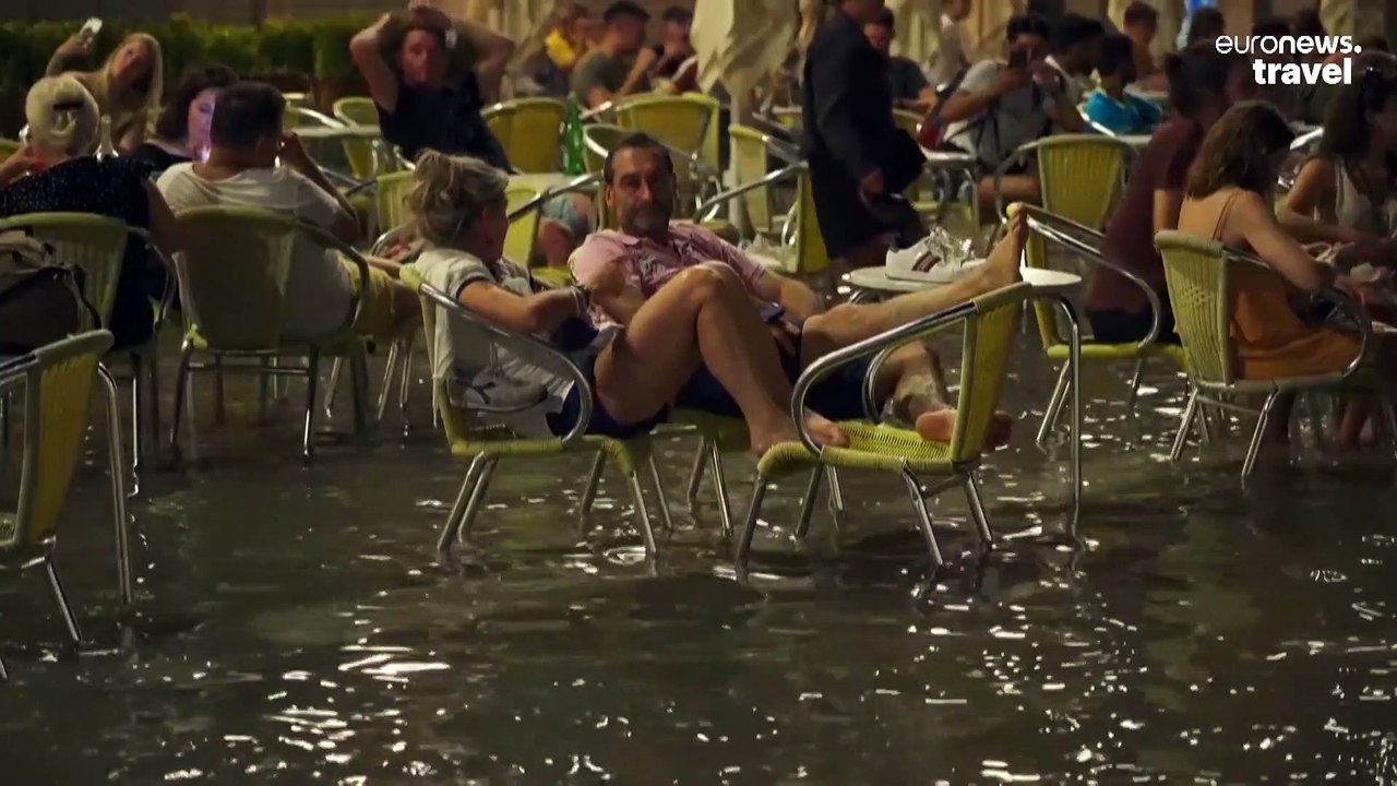 Venice is flooding again: Watch tourists wade through knee-deep water