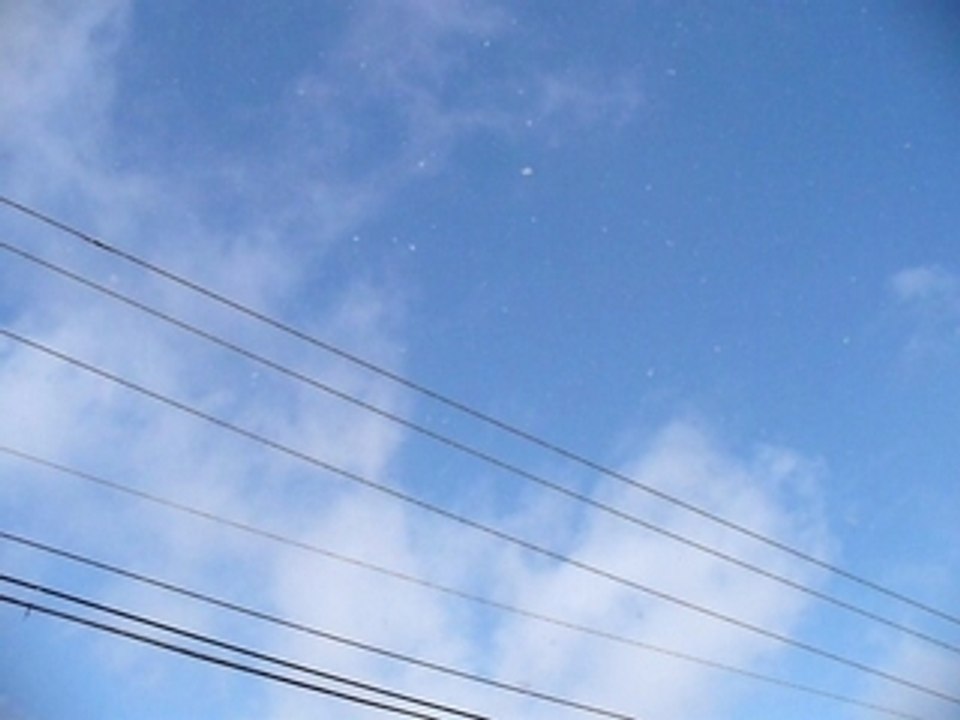 Snow during a blue sky.