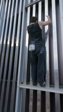 Urban Climber Scales Building in Barcelona