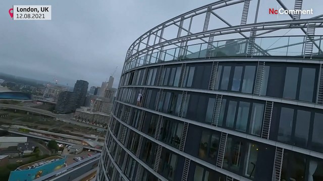 Climber scales London tower to highlight climate change